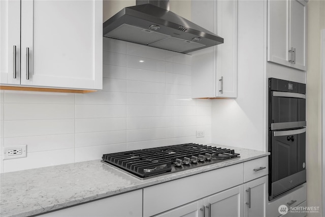 17920 139th Pl E, Puyallup, WA 98374 - kitchen featuring wall chimney exhaust hood, backsplash, stainless steel gas cooktop, white cabinetry, and light stone countertops