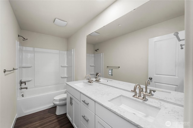 17920 139th Pl E, Puyallup, WA 98374 - bathroom with double vanity, toilet, wood finished floors, and  shower combination