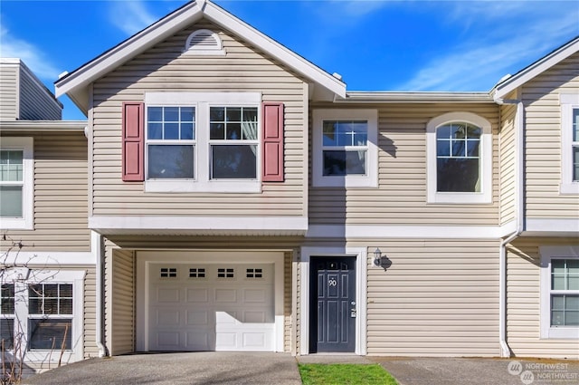 townhome / multi-family property featuring a garage