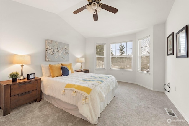 bedroom featuring ceiling fan, vaulted ceiling, and light carpet