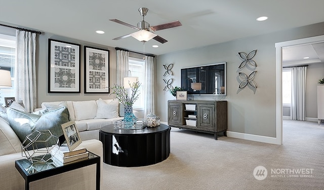 carpeted living room with ceiling fan