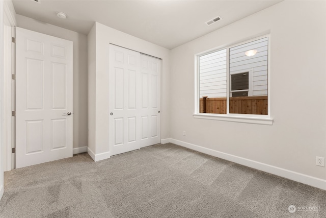 unfurnished bedroom featuring a closet and carpet