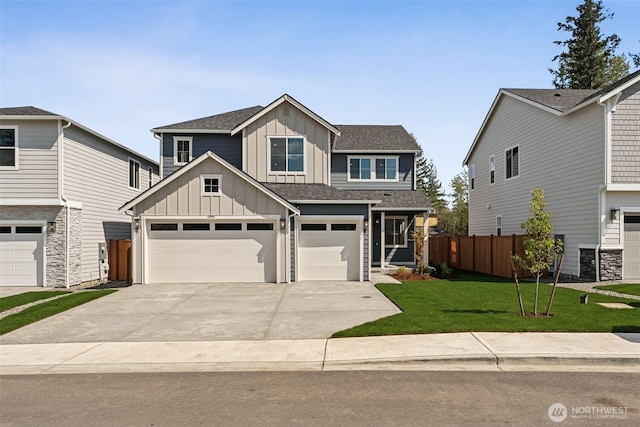 view of front of home featuring fence, a front yard, a shingled roof, board and batten siding, and driveway