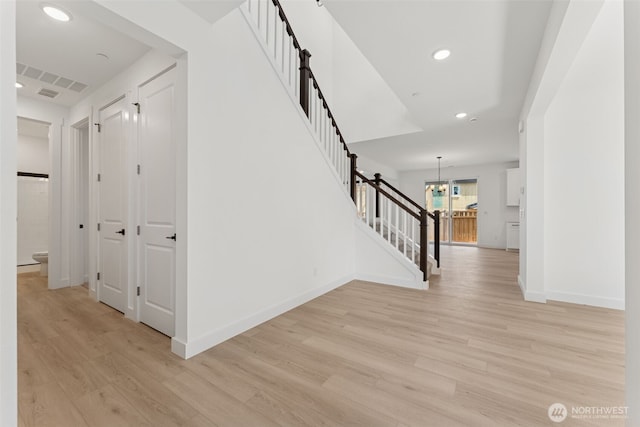 interior space with recessed lighting, baseboards, stairway, and light wood-type flooring