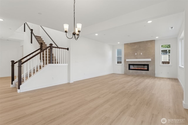 unfurnished living room featuring visible vents, stairway, light wood-type flooring, recessed lighting, and a tile fireplace