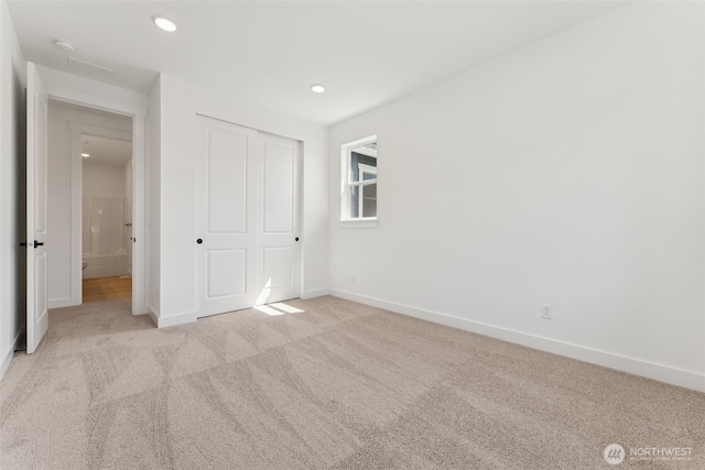 unfurnished bedroom featuring a closet, baseboards, carpet flooring, and recessed lighting