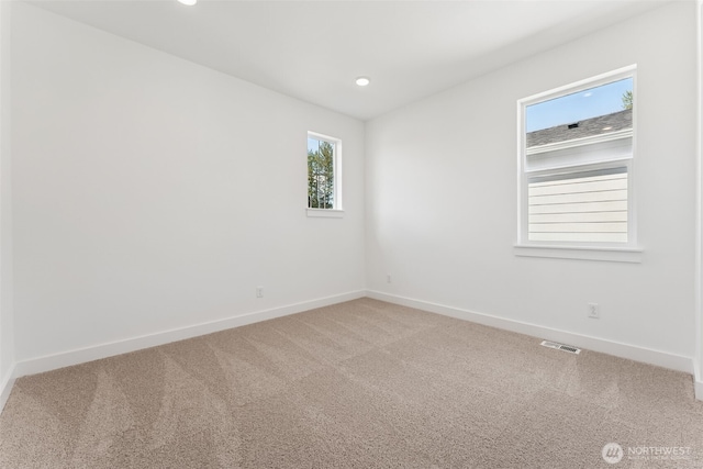 carpeted spare room with baseboards, recessed lighting, and visible vents