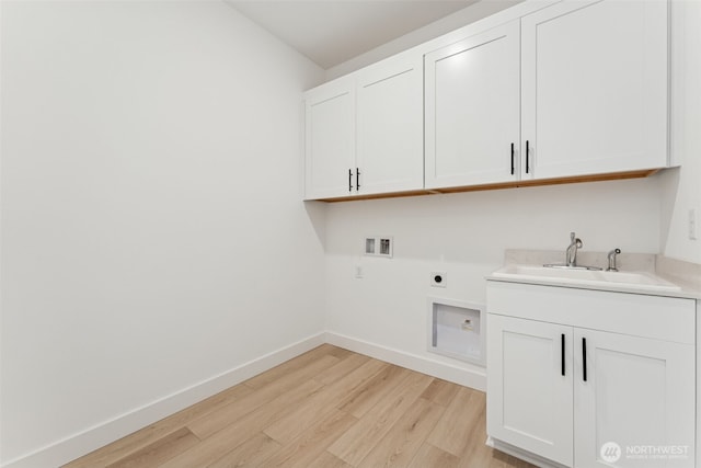 washroom with light wood-style floors, hookup for a washing machine, electric dryer hookup, a sink, and cabinet space