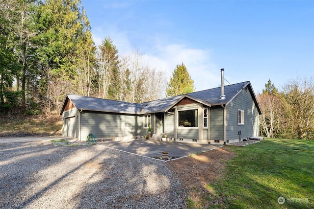 single story home with a front lawn and a garage