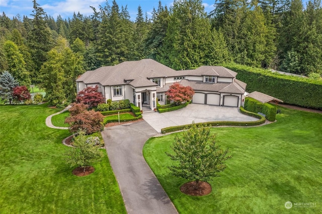 view of front of house featuring a garage and a front yard