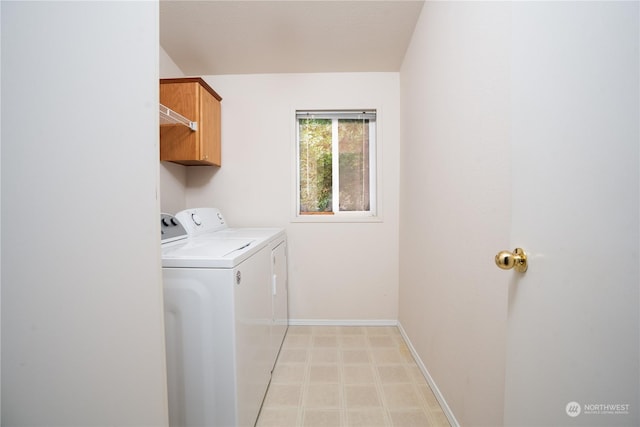 laundry room with cabinets and washer and clothes dryer