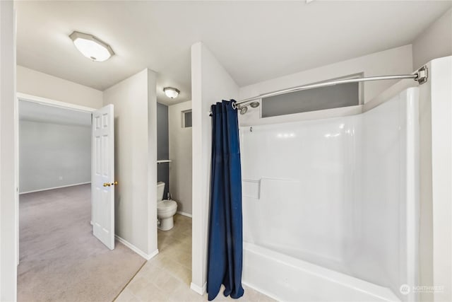 bathroom with toilet and shower / bath combo