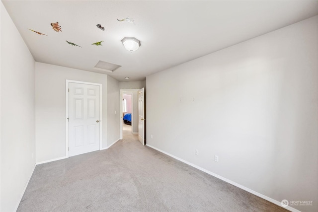 unfurnished room featuring light colored carpet