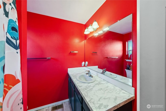 bathroom with hardwood / wood-style floors and vanity