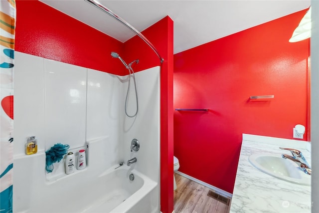 full bathroom featuring vanity, toilet, shower / bath combo with shower curtain, and hardwood / wood-style flooring