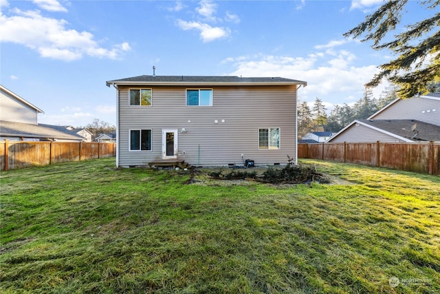 rear view of house featuring a lawn