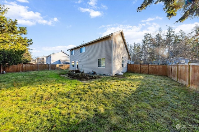 rear view of house featuring a lawn