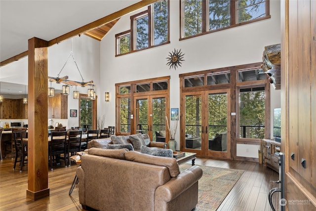 living room featuring french doors, wood-type flooring, high vaulted ceiling, and a wealth of natural light