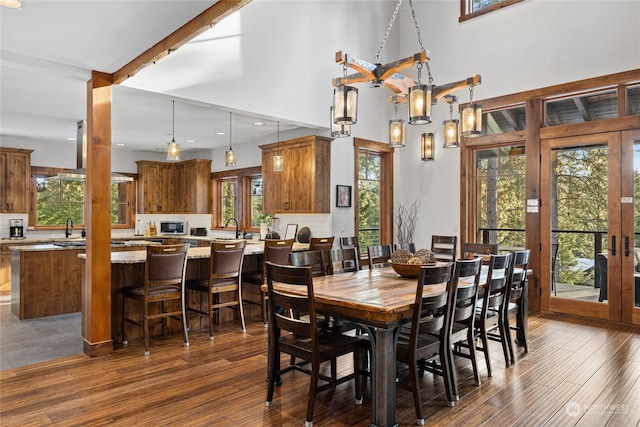 dining room with french doors, dark hardwood / wood-style flooring, sink, and a high ceiling