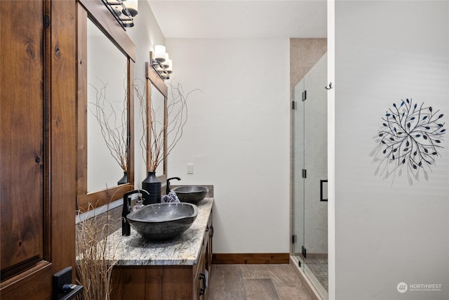 bathroom with vanity and a shower with door