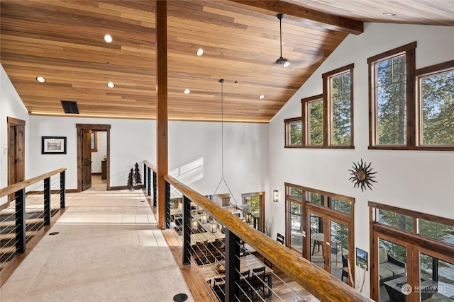 hall with high vaulted ceiling, wooden ceiling, and beam ceiling