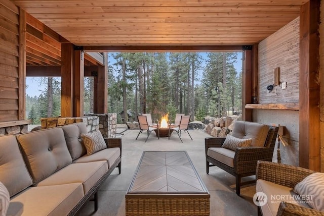 sunroom with a healthy amount of sunlight and wooden ceiling