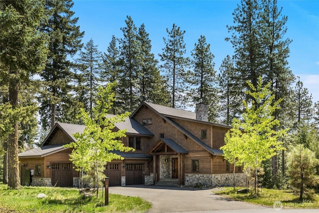 60 Birch Ct, Cle Elum, WA 98922 - view of front facade featuring stone siding, driveway, a chimney, and an attached garage