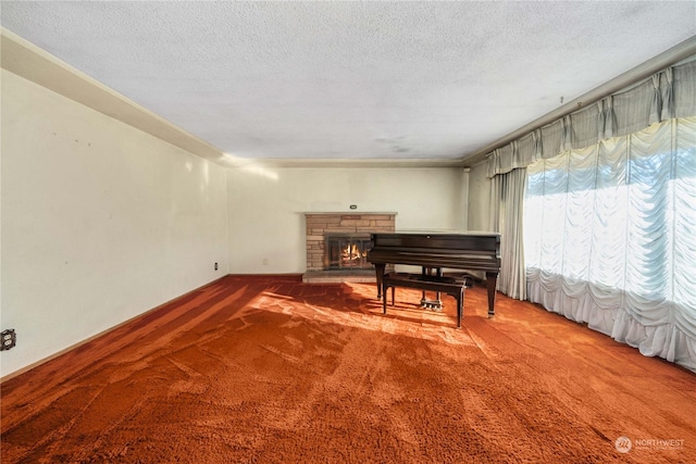 miscellaneous room with a stone fireplace, carpet floors, and a textured ceiling