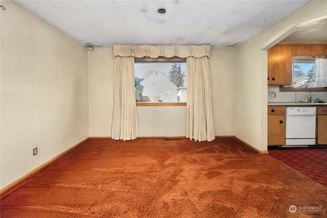 interior space featuring a textured ceiling and dark colored carpet