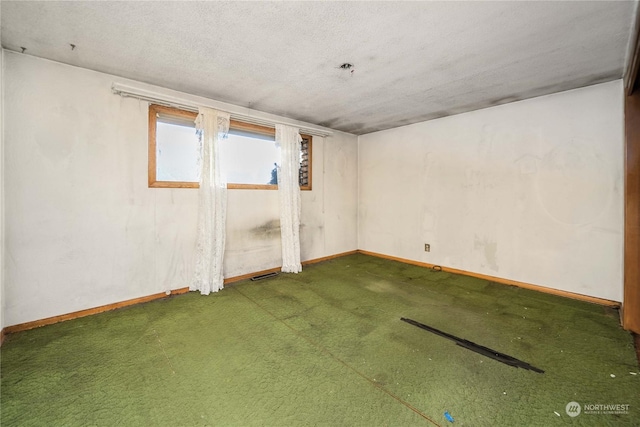 basement with carpet flooring and a textured ceiling