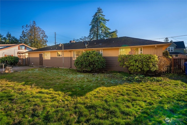 rear view of property with a yard