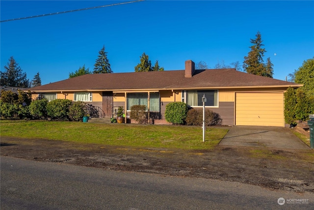 ranch-style house featuring a garage and a front yard