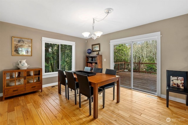 dining room with an inviting chandelier and light hardwood / wood-style floors