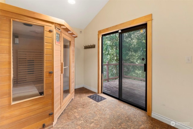 doorway to outside with lofted ceiling