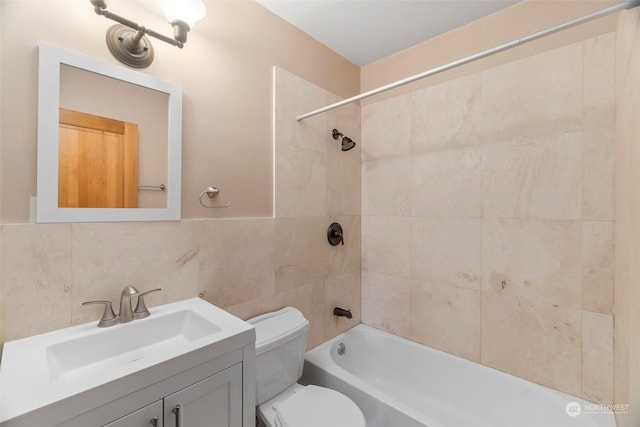 full bathroom with tiled shower / bath combo, vanity, decorative backsplash, tile walls, and toilet