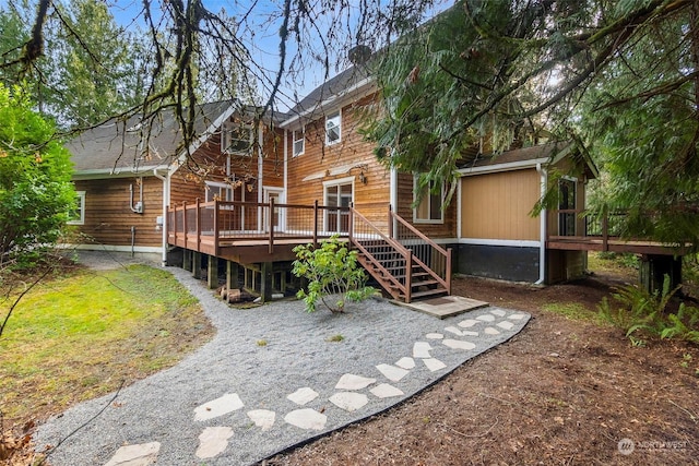 back of house featuring a deck