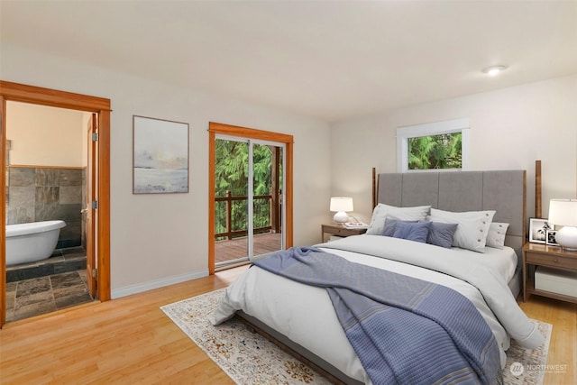 bedroom featuring light wood-type flooring, access to exterior, and ensuite bathroom