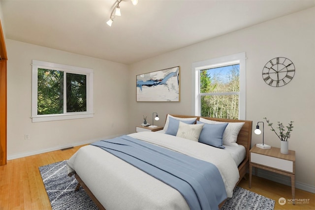 bedroom with wood-type flooring