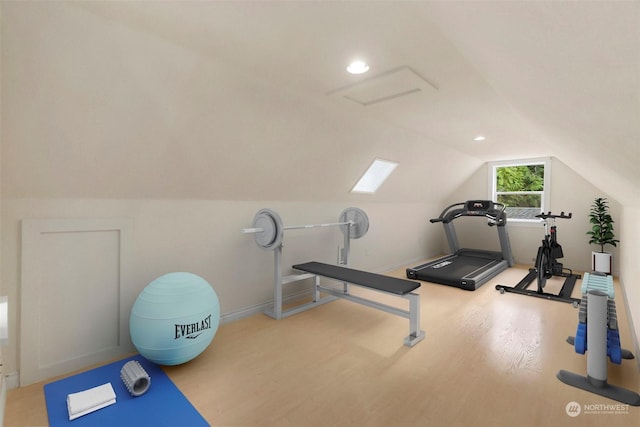 workout area with wood-type flooring and lofted ceiling