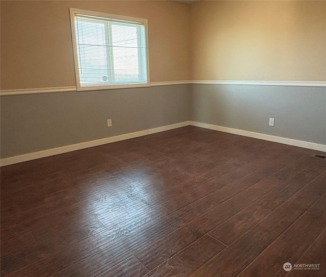 spare room with dark hardwood / wood-style flooring