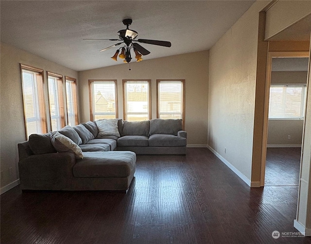 living room featuring ceiling fan, vaulted ceiling, and dark hardwood / wood-style flooring