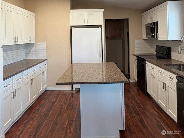 kitchen featuring black appliances, decorative backsplash, and white cabinetry