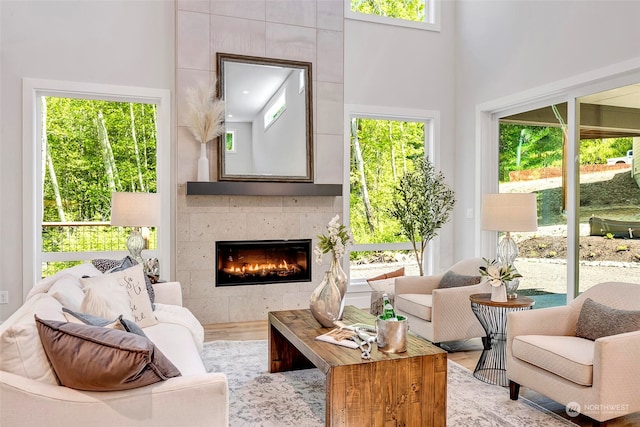 sunroom featuring a healthy amount of sunlight and a tile fireplace