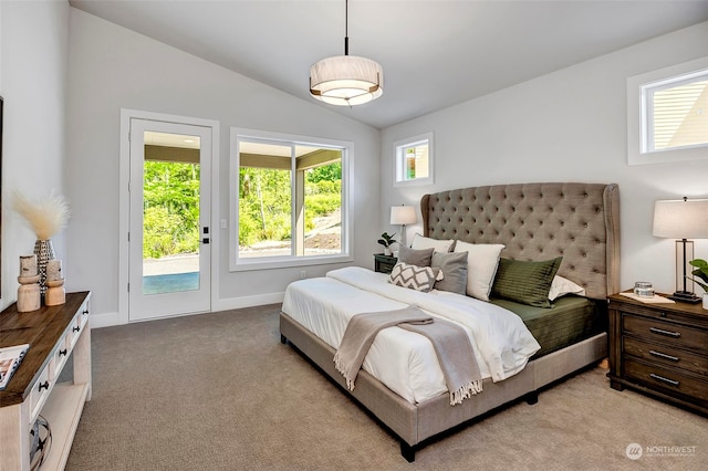 bedroom with vaulted ceiling, light carpet, access to outside, and multiple windows