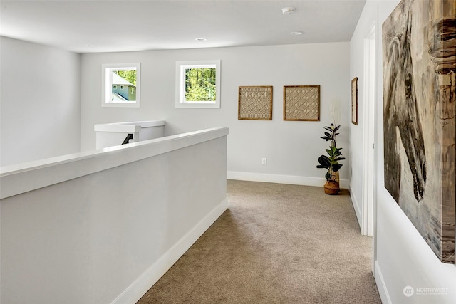 corridor featuring light colored carpet