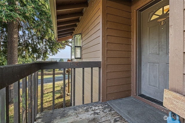 view of exterior entry with a balcony