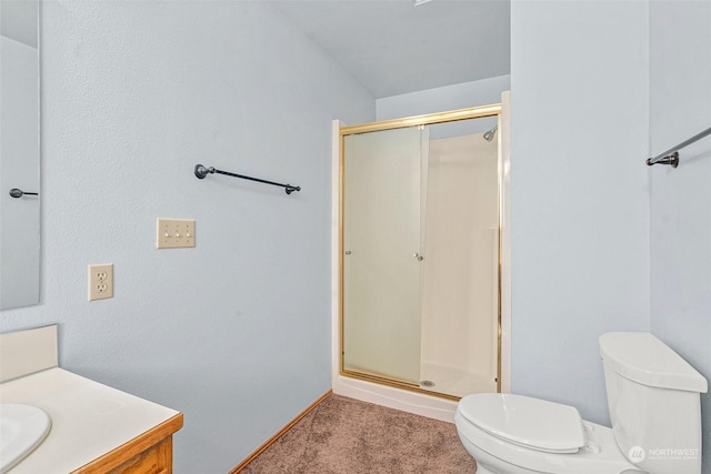 bathroom with a shower with door, toilet, and vanity