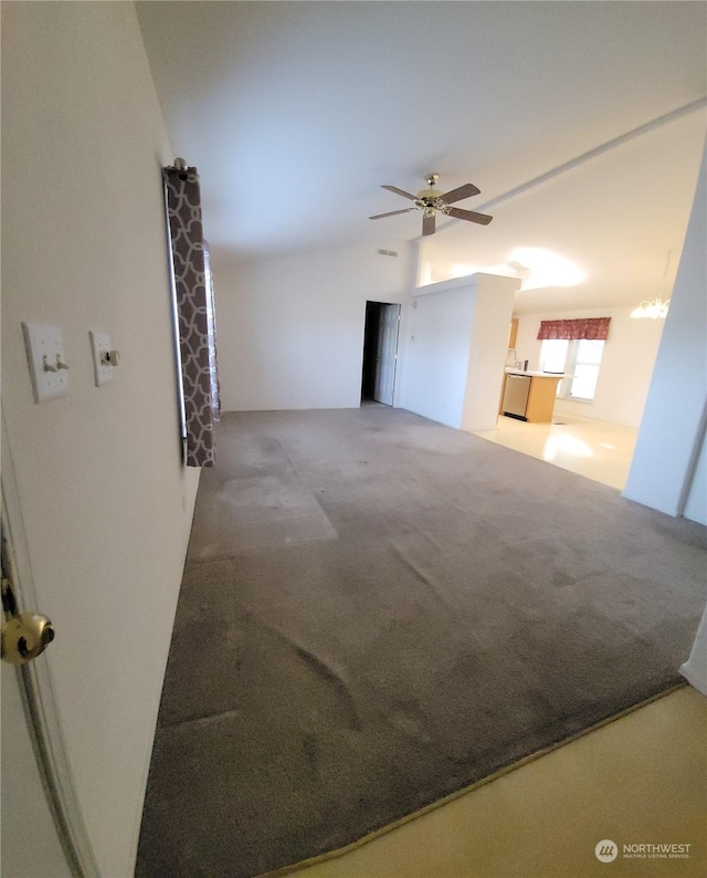 spare room featuring lofted ceiling, ceiling fan, and carpet