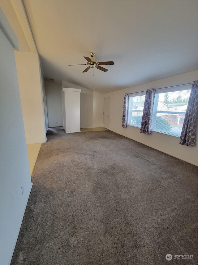 empty room featuring ceiling fan and carpet