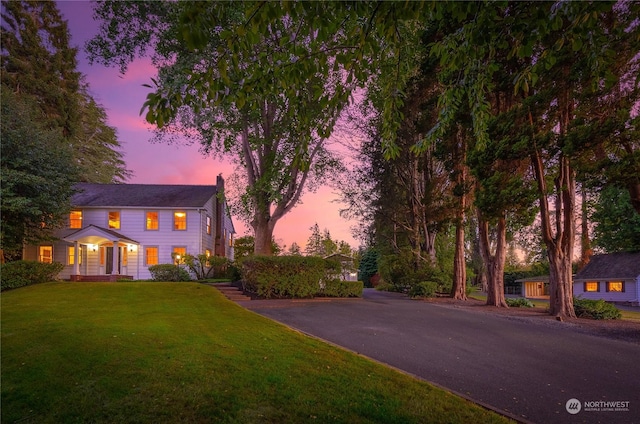 colonial inspired home featuring a yard